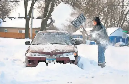  ?? PAT CHRISTMAN, AP ?? Jeremiah Luntsford digs out his car Monday in Mankato, Minn., after a storm spread snow through the much of the Midwest.