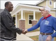  ?? COURTESY OF HABITAT INTERNATIO­NAL ?? Former President Jimmy Carter shakes hands with a volunteer during a Carter Work Project in Fort Worth, Texas.