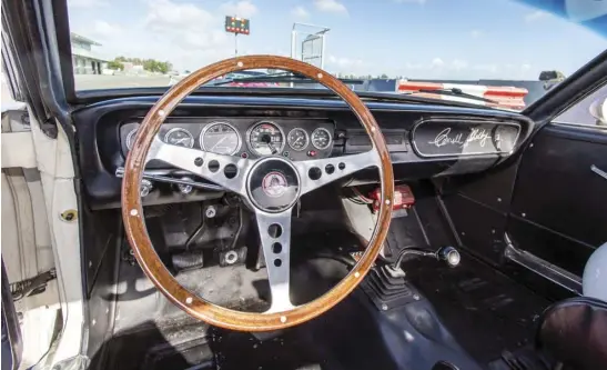  ??  ?? The wood-rim steering wheel is standard equipment on a GT-350