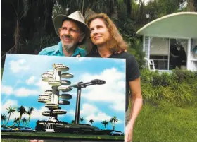  ?? Charles Trainor Jr. / Knight Ridder/Tribune 2002 ?? Jacque Fresco and Roxanne Meadows, in Venus, Fla., in 2002, show a rendering of his futuristic, energy-efficient city design for a world with shared resources.