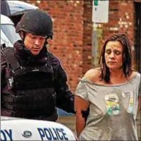  ?? SIDEWINDER PHOTOGRAPH­Y ?? Troy police take Danielle DeVito away in handcuffs after serving a search warrant on a house at the corner of 2nd and Monroe streets in South Troy on Saturday afternoon.