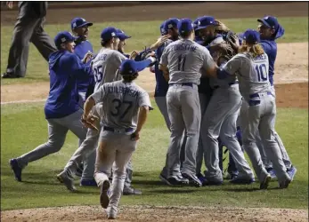  ??  ?? The Los Angeles Dodgers players celebrate after Game 5 of baseball’s National League Championsh­ip Series against the Chicago Cubs on Thursday in Chicago.