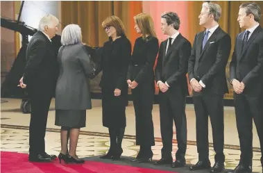  ?? SEAN KILPATRICK / THE CANADIAN PRESS ?? Gov. Gen. Mary Simon and her husband Whit Fraser, left, pay their respects to Mila Mulroney and Mulroney family
members as former prime minister Brian Mulroney lies in state opposite Parliament Hill in Ottawa on Tuesday.