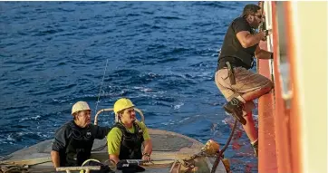  ??  ?? Mayor Shawn Christian jumps on to the supply ship from a longboat.