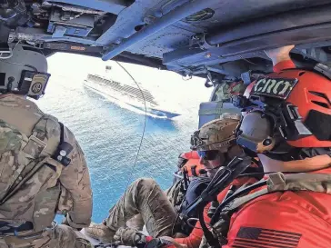  ?? PHOTOS COURTESY OF 920TH RESCUE WING ?? Personnel fly over the Canaveral Venezia cruise ship, preparing for the medical rescue.