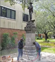  ?? THE ASSOCIATED PRESS ?? Workers begin removing a Confederat­e statue in Gainesvill­e, Florida, on Monday. The statue is being returned to the local chapter of the United Daughters of the Confederac­y, which erected the bronze statue in 1904.