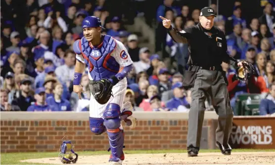  ?? | JAMIE SQUIRE/ GETTY IMAGES ?? Cubs catcher Willson Contreras chases a passed ball that enabled the Dodgers to score a run in the eighth inning of Game 3 of the NLCS atWrigley Field.