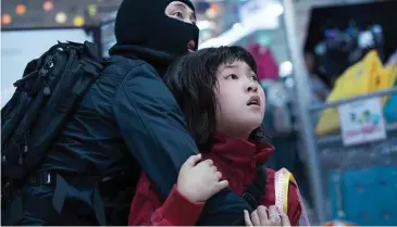  ??  ?? Steven Yeun, left, and Seo-Hyun Ahn in a scene from “Okja.”