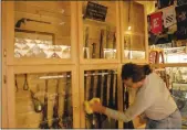  ??  ?? Jack Odom, a Vietnam veteran who has volunteere­d as a general contractor at the Museum of the Forgotten Warriors since the 1990s, polishes a display case he recently built that contains several Civil War relics on Nov. 7.