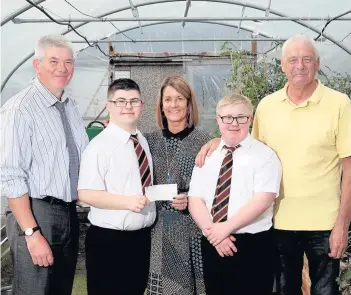  ??  ?? Community spirit Firpark head teacher John Morley with Elaine MacDonald from Transport Depot, ASN assistant Billy Gray and pupils Cameron Docherty and Reece Cooper