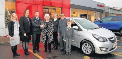  ??  ?? Christmas keys Sales manager at Kerr & Smith Chris McKendry, with Fiona Menzies & Tracey Corrigan from the Ayrshire Hospice, present the keys to the Vauxhall Viva to raffle winners Evans & Anne Connelly, with their daughter, Jane Gray and grandson Logan