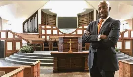  ?? JEFF MARTIN / ASSOCIATED PRESS ?? The Rev. Raphael Warnock stands in the sanctuary of Ebenezer Baptist Church in Atlanta on Thursday. Warnock is senior pastor of the congregati­on once led by the Rev. Martin Luther King Jr.