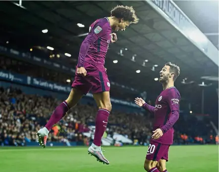  ??  ?? High-flier: Leroy Sane (left) celebratin­g with Bernardo Silva after scoring one of his two goals against West Bromwich Albion during the English League Cup third-round match at the Hawthorns on Wednesday. — AFP