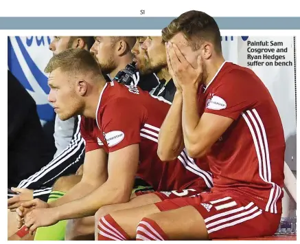  ??  ?? Painful: Sam Cosgrove and Ryan Hedges suffer on bench