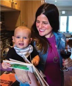  ?? CHRIS DONOVAN/THE CANADIAN PRESS ?? Alana Kayfetz, founder of MomsTO, holds her 1-year-old son, Elias Kantor. Kayfetz has come under criticism for promoting a weekday wine festival for new mothers.