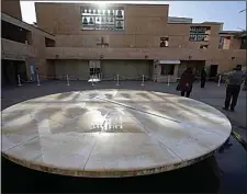  ?? DAMIAN DOVARGANES / AP ?? People stand during a moment of silence to honor 400,000 United States COVID-19 victims outside the Cathedral of Our Lady of Angels in Los Angeles on Tuesday.