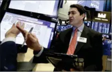  ?? RICHARD DREW — THE ASSOCIATED PRESS ?? Trader Mark Muller works on the floor of the New York Stock Exchange, Wednesday. U.S. stocks were mixed in the morning as investors waited for news on interest rates from the Federal Reserve.