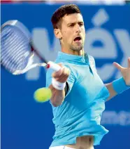  ?? —AP ?? Novak Djokovic hits a forehand return en route to his 6-3, 76 (4) victory over Martin Klizan on Tuesday.