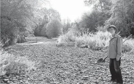  ?? CAROL VALENTINE VIA AP ?? Jack Dwyer stands on the dry creek bed of Deer Creek in Selma, Oregon. Illegal marijuana growers stole water from the stream.