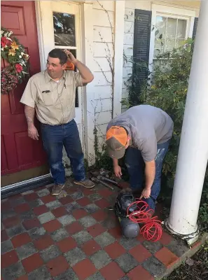  ?? Staff photo by Andrew Bell ?? ■ John, left, and Carter Bowman on the job at an Ashdown residence.