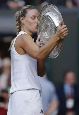  ?? Picture: AFP ?? LOOK OF LOVE. Germany’s Angelique Kerber with the famous Venus Rosewater Dish after beating Serena Williams in the Wimbledon final on Saturday.