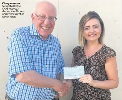  ??  ?? Cheque mates Samantha Reilly of CHAS receives a cheque from Mr John Andrew, President of Girvan Rotary