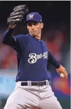  ??  ?? Brewers starter Brent Suter delivers a pitch Tuesday night at Busch Stadium. He didn’t give up a hit until the fifth inning.