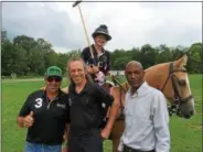  ??  ?? Saratoga Polo Associatio­n has begun using helmetmoun­ted cameras to give fans a better view of the game. Olivia Reynolds, 14, seated on her horse, tries out the new technology. From left to right, front, are the associatio­n’s Director of Polo Cuko...