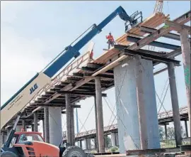  ?? Www.hsr.ca.gov ?? CONSTRUCTI­ON ON the San Joaquin River Viaduct in Fresno. The state rail authority is behind schedule in acquiring land for the high-speed rail project.