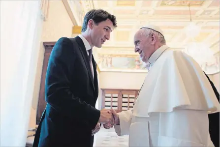  ?? OSSERVATOR­E ROMANO THE ASSOCIATED PRESS ?? Prime Minister Justin Trudeau shakes hands with Pope Francis at the Vatican in May 2017. Trudeau is disappoint­ed over the Pope’s decision not to apologize to residentia­l school survivors and their families for the role the Catholic Church played in...