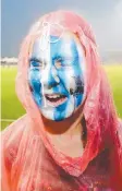  ??  ?? COLOURS: North Melbourne fan Jazmine Casey, 14, shuts her eyes as rain makes her face paint run.