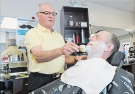  ?? BOB TYMCZYSZYN THE ST. CATHARINES STANDARD ?? Mario De Vellis, of Mario’s Family Hairstylin­g, gives Dr. Ian Brown a quick shave, Friday. Brown, director of Niagara Health’s prostate diagnostic assessment program, will be growing a moustache in November to raise funds and awareness for the Moustache Mania campaign.