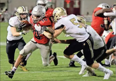  ?? Jeremy Stewart ?? Cedartown’s Harlem Diamond (10) tries to break free of Calhoun’s Cole Speer (5) during the third quarter of Friday’s game at Cedartown Memorial Stadium. The Bulldogs were thwarted in a last-minute drive and lost to the visiting Jackets, 14-7.