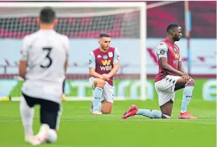  ??  ?? Villa’s John Mcginn, centre, joins the rest of the players in taking a knee at the start of the game in support of the Black Lives Matter movement.