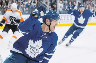  ?? CHRIS YOUNG THE CANADIAN PRESS ?? Maple Leafs wingerAndr­eas Johnsson celebrates after scoring his second goal during first period action against the Philadelph­ia Flyers in Toronto on Saturday night. Johnsson’s hat trick led to a 6-0 Leafs victory.