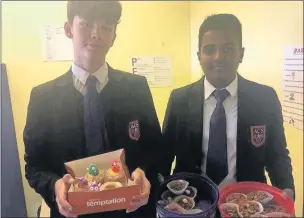  ??  ?? n SWEET GESTURE: Year 11 pupils Tom Leaning (left) and Sajan Surenthira­rajah with their cakes baked for Neuroblast­oma awareness
