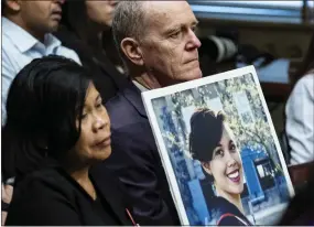  ?? PETE MAROVICH THE NEW YORK TIMES ?? Chris and Clariss Moore hold a photo of their daughter, Danielle Moore, during a hearing of the Senate Homeland Security and Government­al Affairs Committee's investigat­ions subcommitt­ee in Washington on Wednesday. She was killed when Ethiopian Airlines Flight 302, a Boeing 737 Max 8, crashed on March 10, 2019.