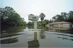  ?? GERALD HERBERT/AP ?? Tropical Storm Claudette flooded a neighborho­od in Slidell, La., on June 19.