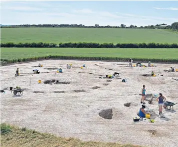  ??  ?? Part of the dig at Winterborn­e Kingston in Dorset. The remains of 16 roundhouse­s have been found, but there could be 200 in total