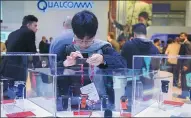  ?? GETTY IMAGES ?? Visitors examine new Qualcomm wearable devices during the Mobile World Congress 2017 in Barcelona, Spain.