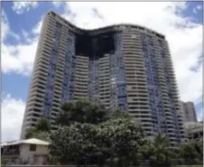  ?? MARCO GARCIA — THE ASSOCIATED PRESS FILE ?? In this file photo the Marco Polo building is shown after a fire the day before gutted several of the top floors of the residentia­l high-rise in Honolulu.