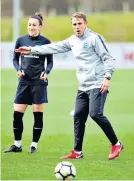  ??  ?? In charge: Phil Neville takes training