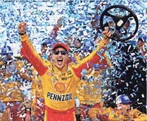  ?? PETER CASEY/USA TODAY SPORTS ?? Joey Logano celebrates winning the First Data 500 Sunday at Martinsvil­le Speedway.