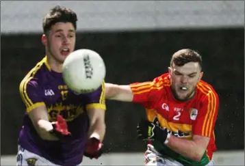  ??  ?? Goalscorer Mikie Dwyer is challenged by Carlow defender Conor O’Doherty.