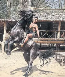  ??  ?? ALONG FOR THE RIDE: Buakaw as street fighter and historical figure Thongdee in the new drama film ‘Thongdee Fun Khaw’.