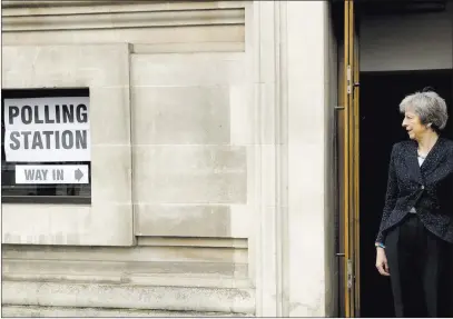  ?? Matt Dunham ?? The Associated Press British Prime Minister Theresa May pauses for photograph­ers after voting Thursday in local council elections in London.