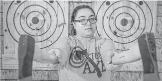  ?? Houston Chronicle ?? Top: Sarah Sed is the owner of Houston Axe Throwing. Left: Chronicle features writer Maggie Gordon tries her hand at ax throwing at the facility located in southwest Houston.