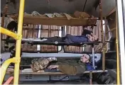  ?? RUSSIAN DEFENSE MINISTRY PRESS SERVICE VIA AP ?? Wounded Ukrainian servicemen lay in a bus as they are being evacuated from the besieged Azovstal steel plant in Mariupol, Ukraine, as shown in a photo taken from video released by the Russian Defense Ministry Press Service on Tuesday.