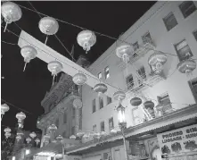  ??  ?? Lanterns hang above Chinatown’s Grant Avenue in San Francisco. Many of the buildings in the neighbourh­ood can be traced to reconstruc­tion efforts after the 1906 earthquake.