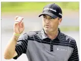  ?? AP ?? Ryan Palmer acknowledg­es the crowd at PGA National in Palm Beach Gardens, Fla., after wrapping up a 5-under 65 in Friday’s second round of the Honda Classic. He shares the lead with Wesley Bryan.